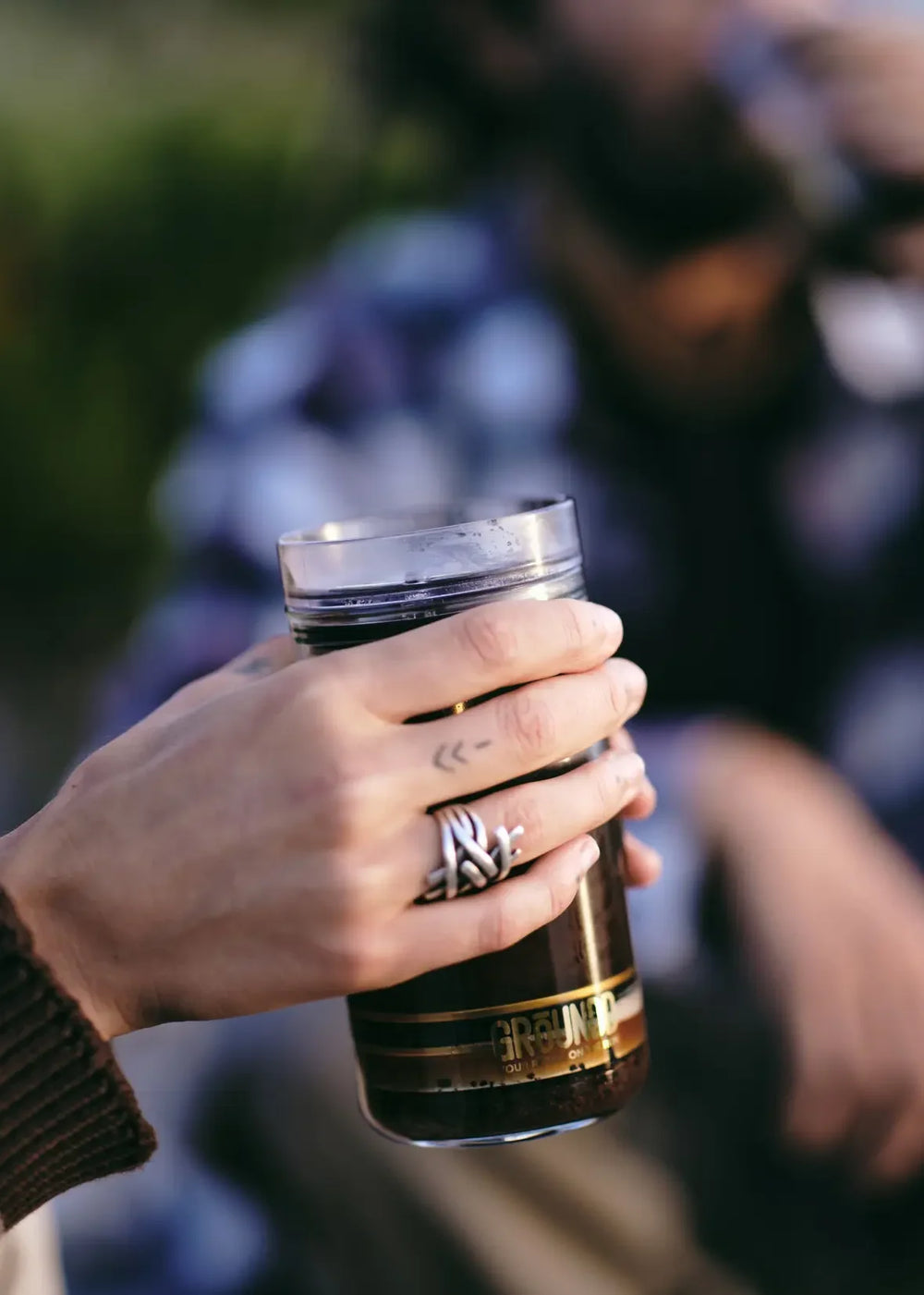 A GROUNDD xpress held in the hand, ready to drink