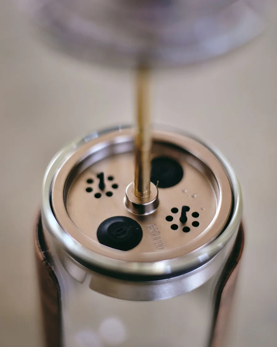 The piston, the filter and the prototype parts on the workshop bench