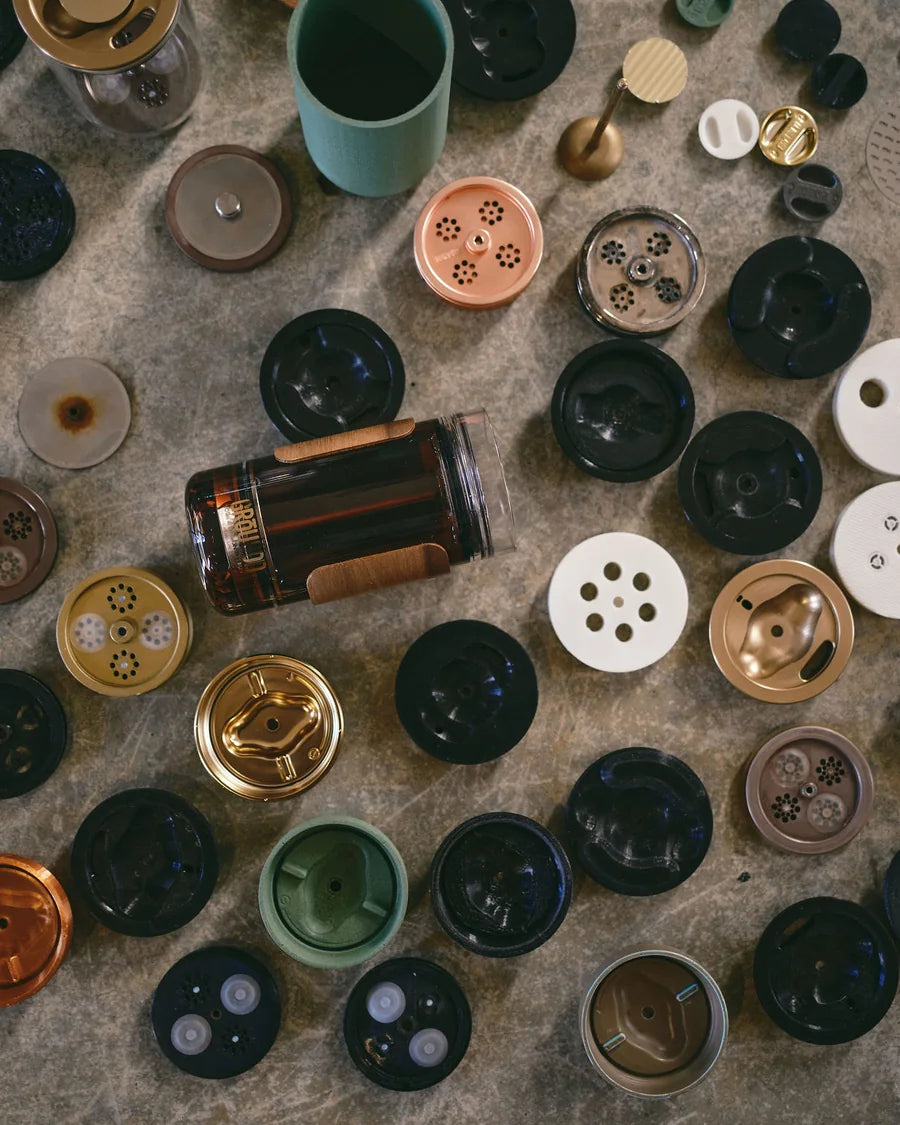 The piston, the filter and the prototype parts on the workshop bench