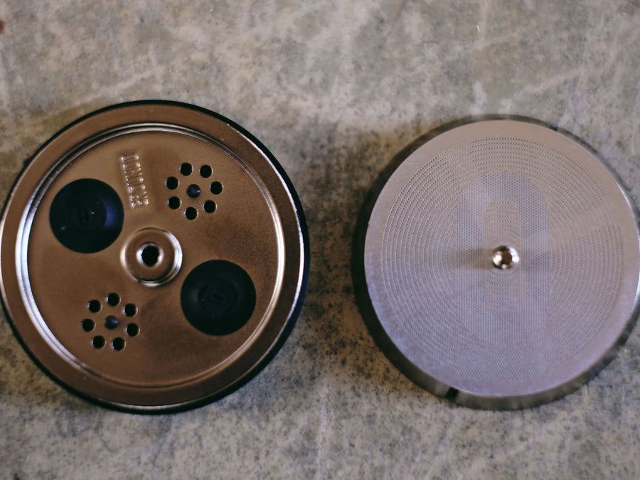 The piston, the filter and the prototype parts on the workshop bench