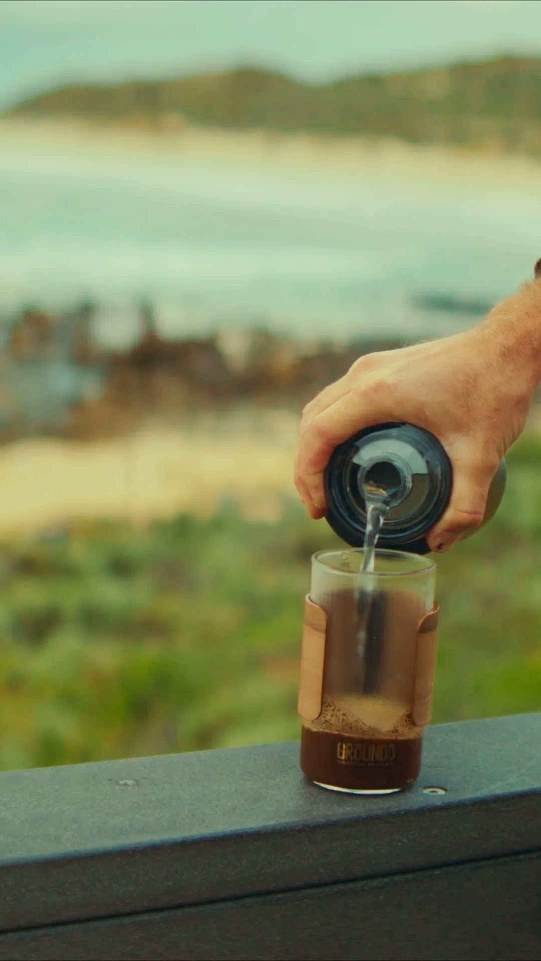 Pouring hot water into a GROUNDD xpress above a Western Australian bay
