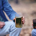 Green tea steeping in the GROUNDD xpress, held in hand