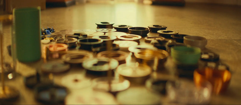 Rows of assembled cups and components on the bench