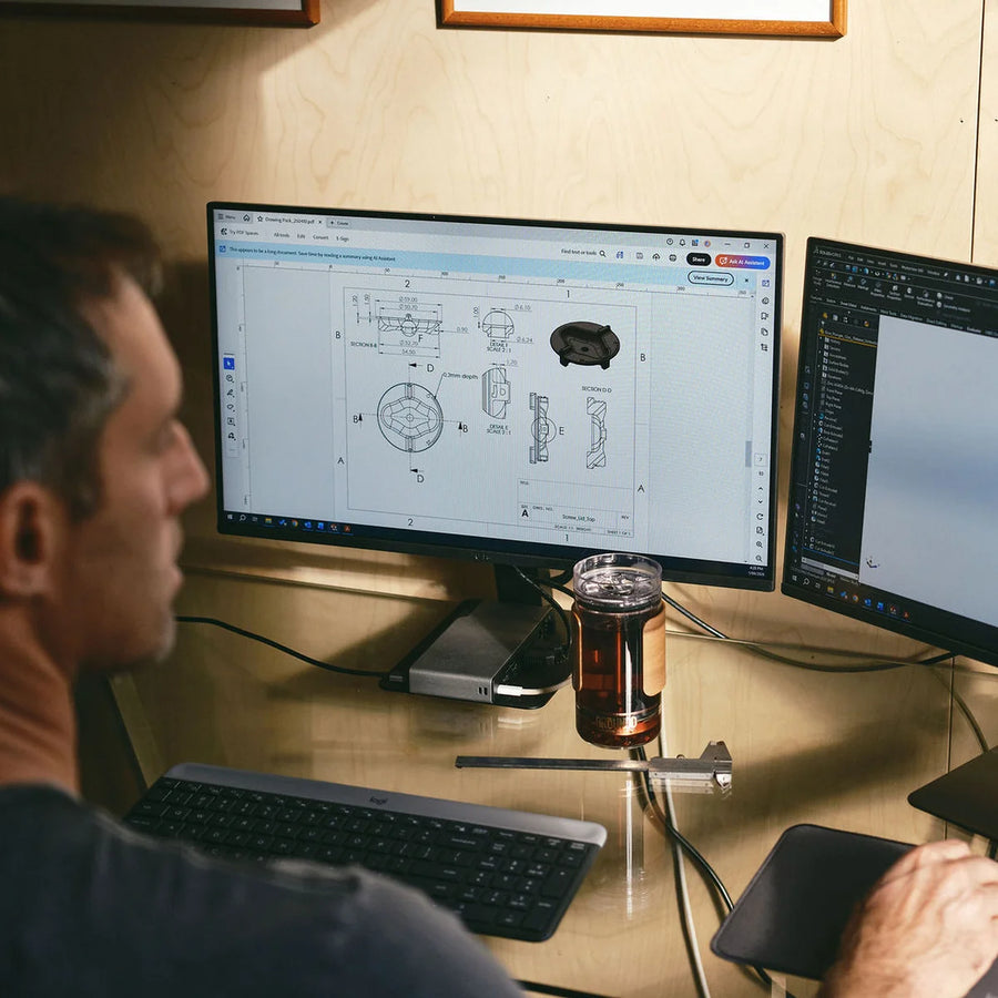 Nick at his workstation with the lid modelled on screen and the cup on the desk